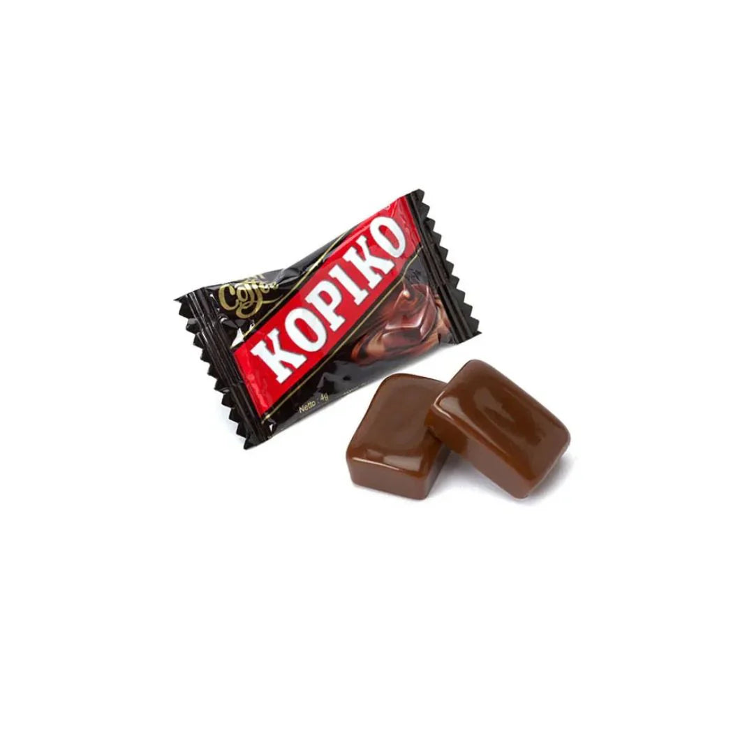 A wrapped Twice as Sweet Kopiko Coffee Candy 175g (Indonesia) sits beside two unwrapped, glossy brown coffee candies—iconic Indonesian sweets—shown on a white background.
