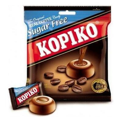 A 75g package of Twice as Sweet Kopiko Sugar Free Coffee Candy (Indonesia) is shown, with coffee candies and beans on the brown, black, red, and blue packaging, plus one individually wrapped candy in front.