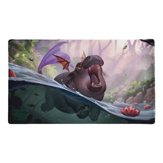 Illustrated Snortle hippo-dragon emerging from water with a fantasy forest background