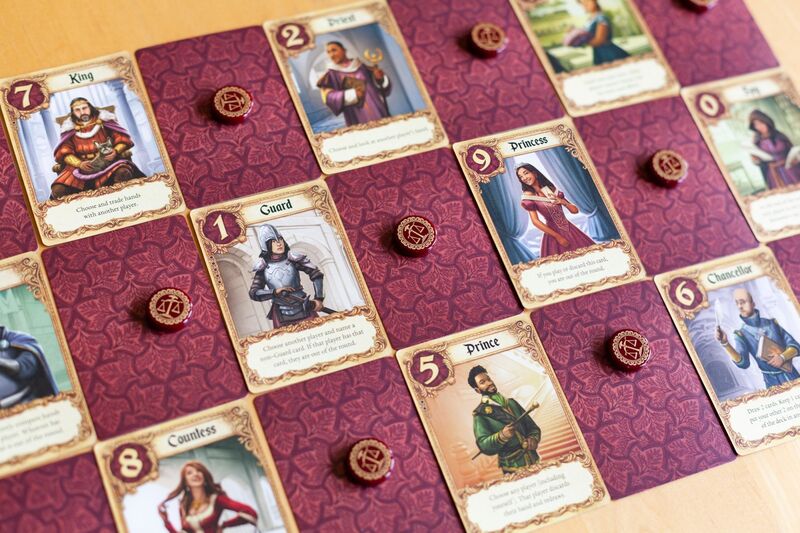 Love Letter board game with character cards and game pieces on a patterned surface