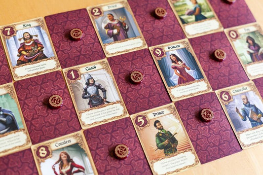 Love Letter board game with character cards and game pieces on a patterned surface