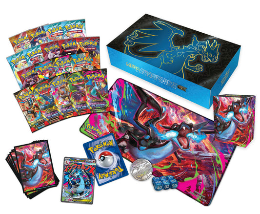 Collection of Pokémon trading cards with a large display box featuring a dragon-like creature Mega Charizard X ex.