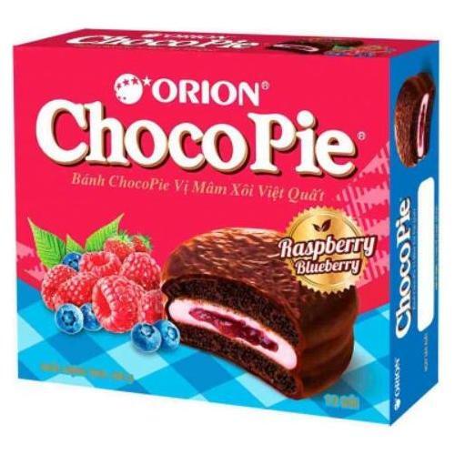 Orion Choco Pie Raspberry Blueberry 12 Pack (Vietnam) by Twice as Sweet features chocolate-covered pies with fruity raspberry and blueberry filling, shown on a vibrant pink and blue box decorated with berries.