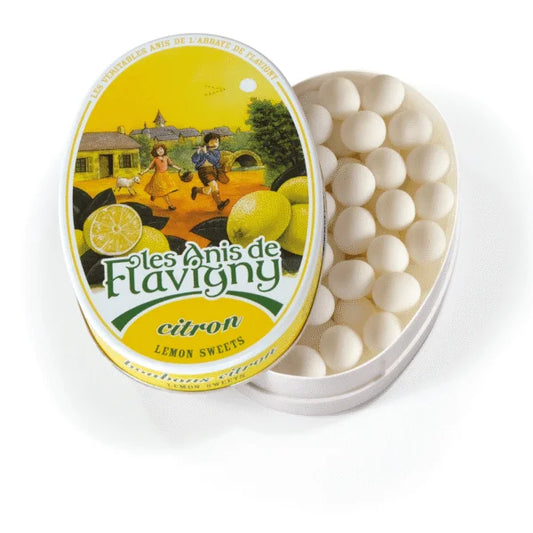 The Twice as Sweet Anis De Flavigny Lemon 50g tin from France features a vintage countryside design on its lid and contains classic round white lemon candies.