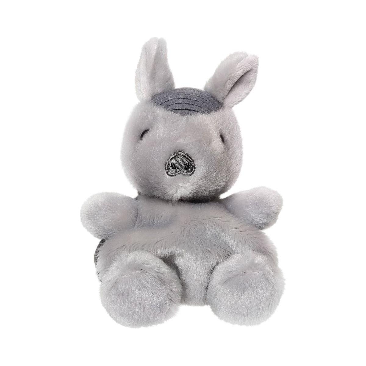 A small, gray plush kangaroo with closed eyes and large ears sits upright against a white background next to the Palm Pal Antonia Armadillo plush by Twice as Sweet.