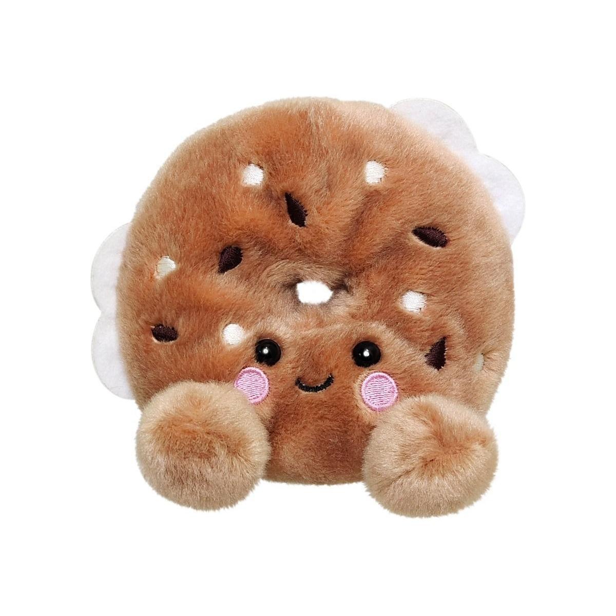 Palm Pal Tony Everything Bagel by Twice as Sweet is a plush toy styled as an everything bagel with a cute embroidered face, pink cheeks, and fluffy paws—perfect for adding charm to any collection. Background is plain white.