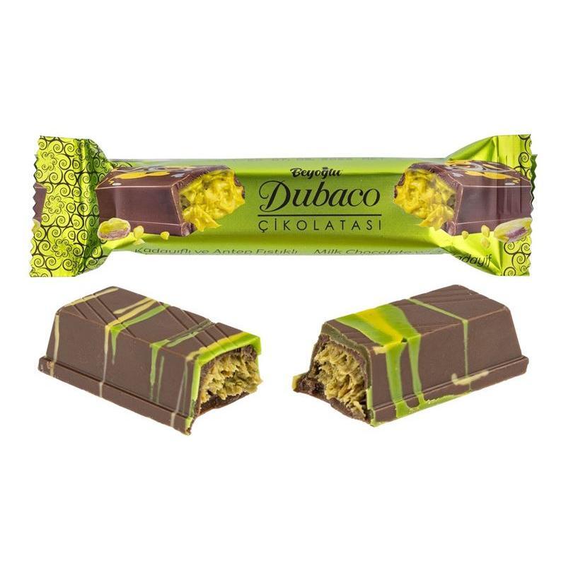 A chocolate bar with brown and green stripes, one whole and one split to reveal a crunchy filling. The wrapper reads Beyoglu Dubaco Dubai Pistachio Chocolate (Turkey) from Twice as Sweet, inspired by Middle Eastern desserts.