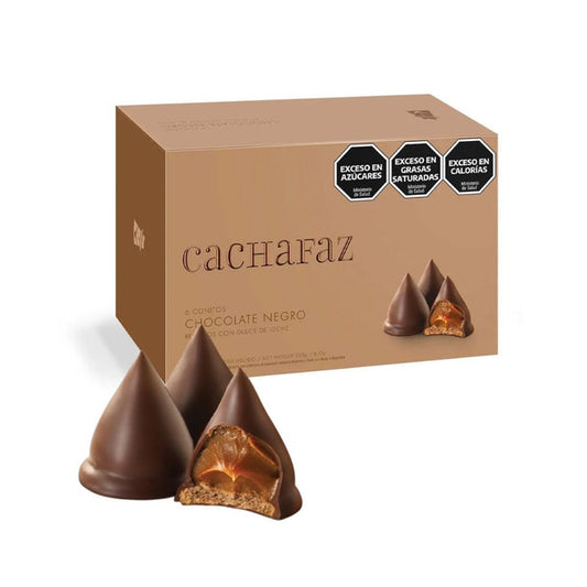 A brown box of Twice as Sweet Cachafaz Dulce De Leche Chocolate Cones 228g (Argentina) is shown with two pyramid-shaped chocolate cones, one cut to reveal dulce de leche filling. The box has warnings for excess sugar, saturated fat, and calories.