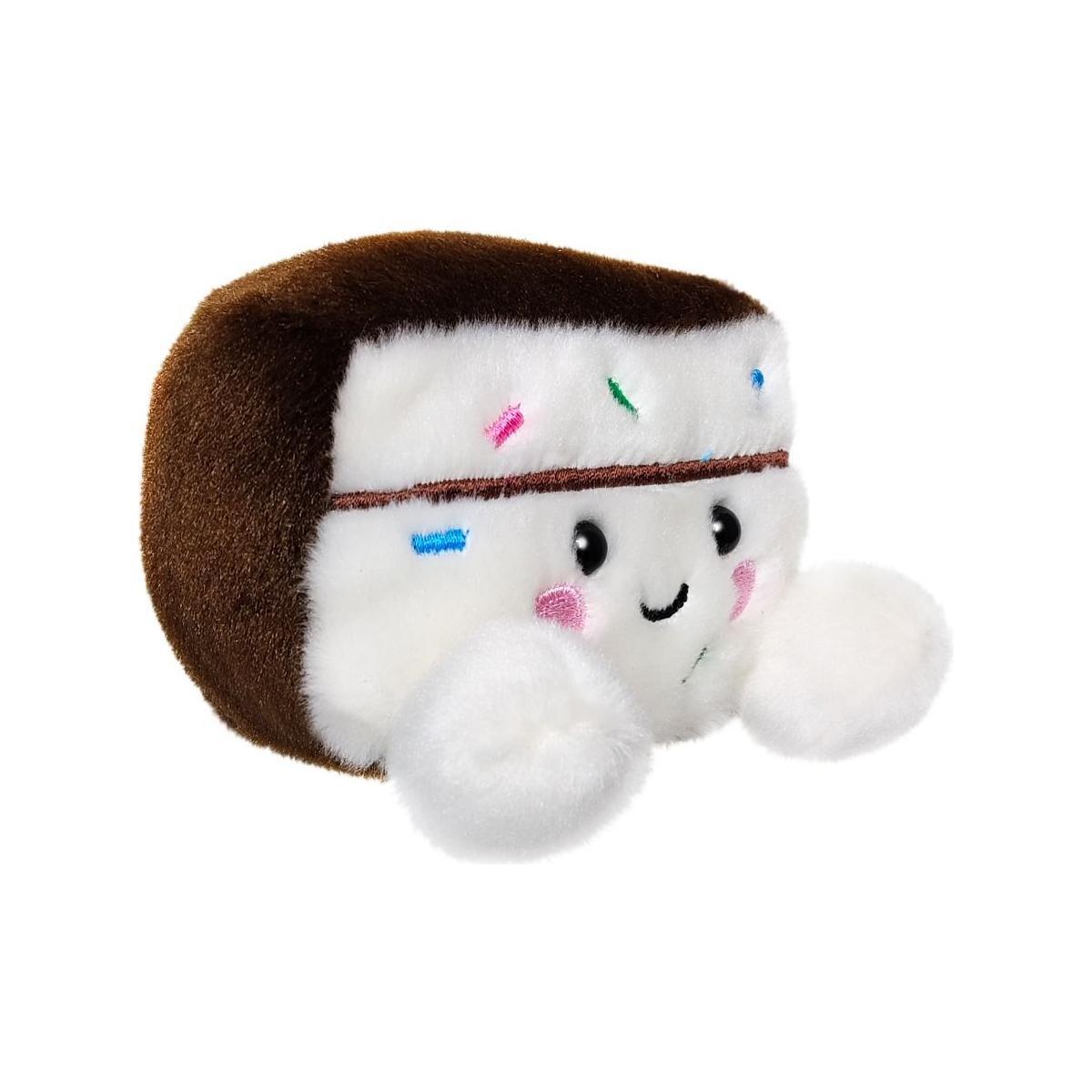 The Twice as Sweet Palm Pal Sprinkles Cake Slice is a celebration plush with a smiling face, pink cheeks, colorful sprinkles, and fluffy white feet, shown against a white background.