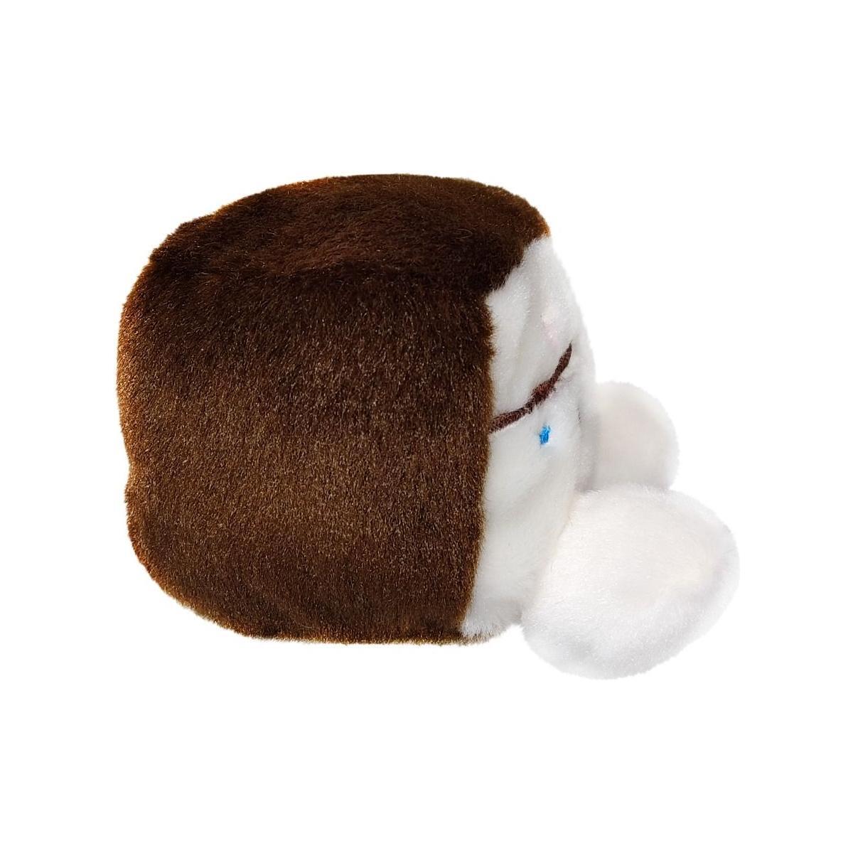 The Twice as Sweet Palm Pal Sprinkles Cake Slice is a cube-shaped plush toy with brown and white sides, a stitched face, and a small blue teardrop—resembling a sad slice of cake at the end of the party.