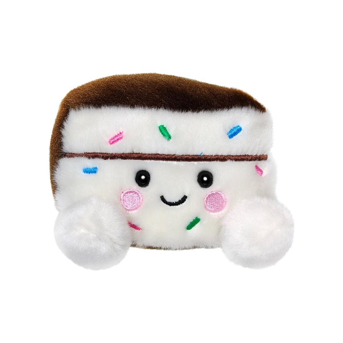 The Twice as Sweet Palm Pal Sprinkles Cake Slice plush toy features a smiling cake slice with white filling, brown edges, pink cheeks, black eyes, colorful sprinkles, and two fluffy white paws for party fun in every hug.