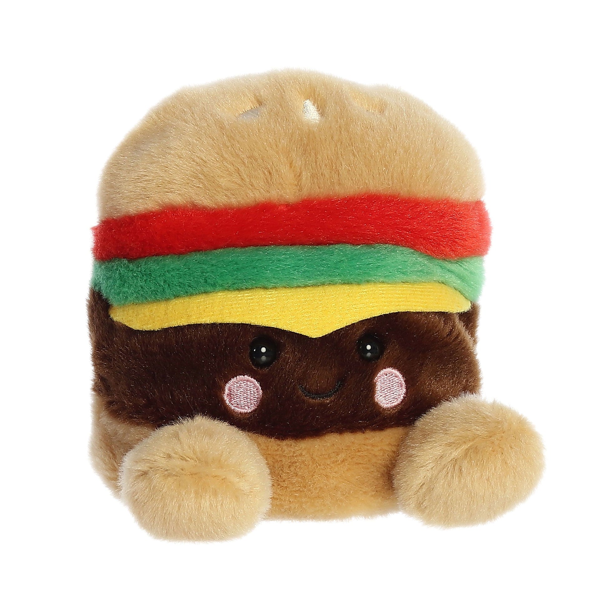 The Twice as Sweet Palm Pal Charles Cheeseburger is a plush stuffed toy with a smiling face, black eyes, pink cheeks, and soft textures in brown, tan, red, green, and yellow to represent a cheeseburger.