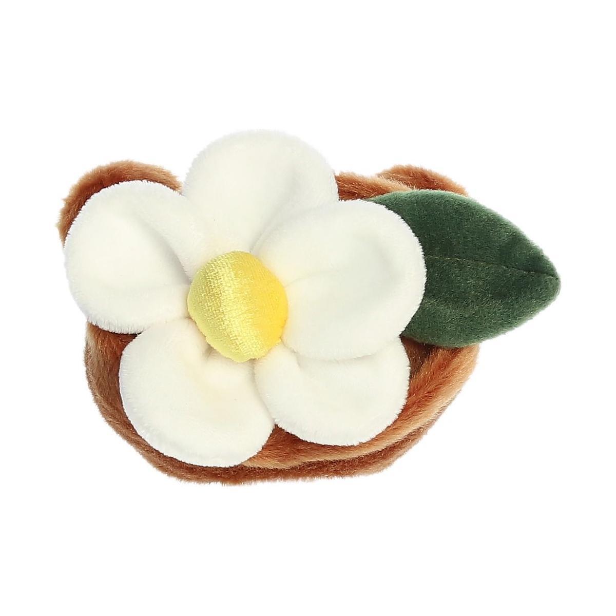 The Twice as Sweet Palm Pal Junie Daisy is a plush toy with a white and yellow flower, green leaf, and soft brown base—ideal as whimsical party decor or for cuddling.