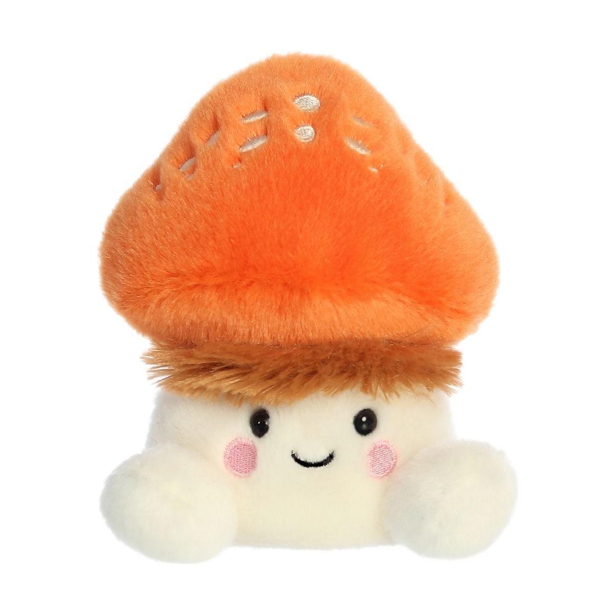 The Twice as Sweet Palm Pal Fabian Fluffy Mushroom is a plush toy featuring a smiling face, orange cap, white body, pink cheeks, and black eyes—perfect for bringing a whimsical party vibe to any room.