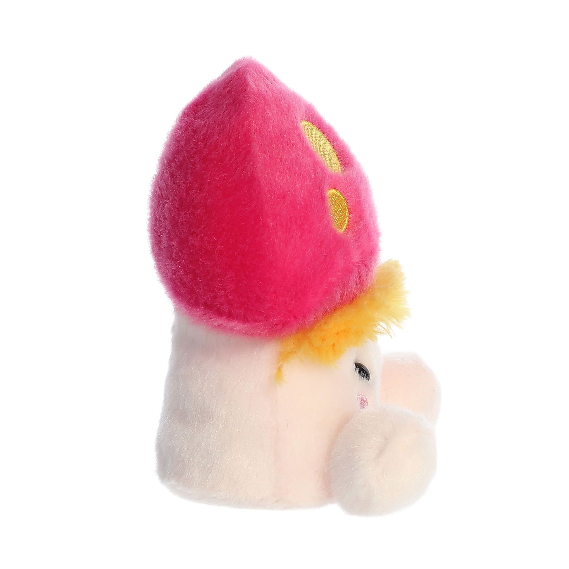 Meet the Palm Pal Favio Fluffy Mushroom by Twice as Sweet—a soft, whimsical plush with a bright pink cap, yellow spots, and a round beige face featuring a yellow tuft of hair, small eyes, and a cute round nose.