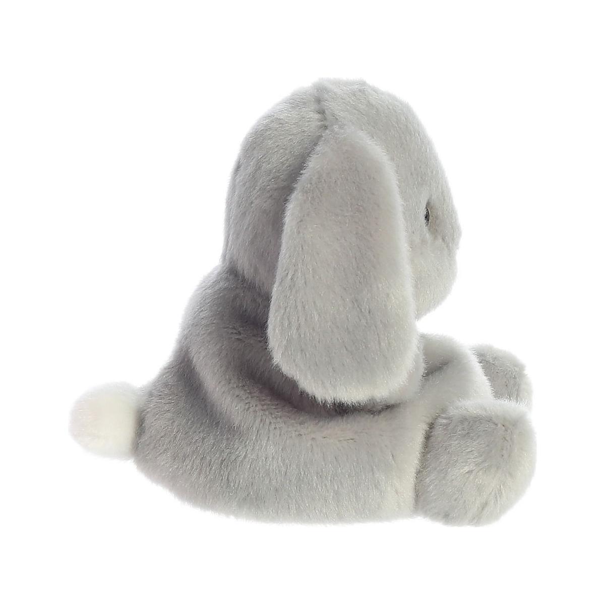 The Twice as Sweet Palm Pal Pebbles Bunny features cuddly, soft slate-grey fur, floppy ears, and a small white tail, sitting sideways against a white background.