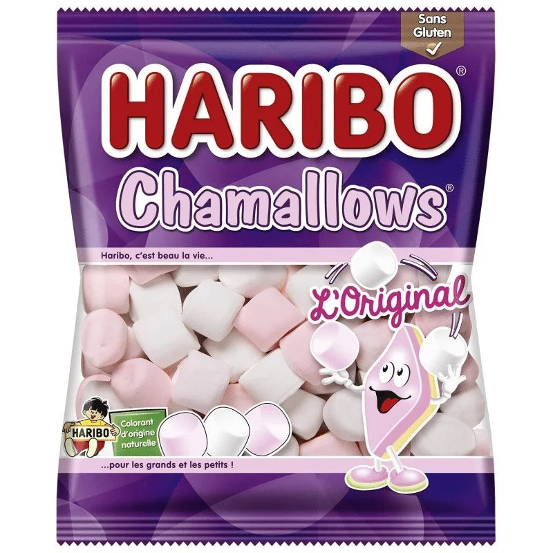 A 100g bag of Twice as Sweet Haribo Chamallows (France) BB: 10/25, with pink and white vanilla marshmallows in a purple pack featuring a smiling marshmallow cartoon holding skewered treats on the front.