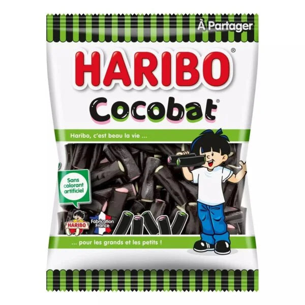 A 300g bag of Haribo Cocobat from Twice as Sweet, featuring black licorice sticks in mostly white packaging with green accents and French text, plus a cartoon boy holding a stick.