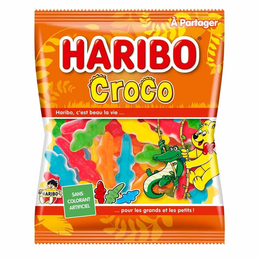 A 280g bag of Twice as Sweet Haribo Croco gummies from France features colorful crocodile and bear cartoons, French text, and a clear window displaying multicolored candies inside.