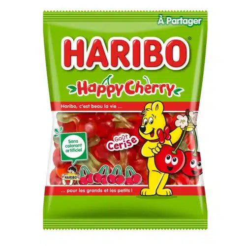 A green bag of Twice as Sweet Haribo Happy Cherry 200g (France) features red cherry-shaped gummies and playful French packaging with a cartoon bear holding cherries and delightful cherry illustrations.