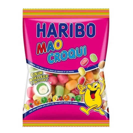 A colorful bag of Twice as Sweet Haribo Mao Croqui 250g (France) BB:11/25 sits on a pink background, showing assorted chewy candies through a clear window and featuring a waving yellow cartoon character on the packaging.