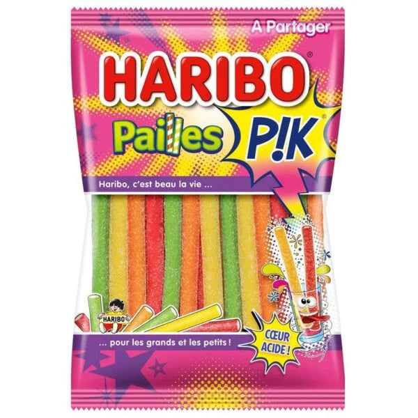 A 180g pack of Haribo Pailles Pik (France) by Twice as Sweet, featuring vibrant yellow, orange, green, and red sour candy straws. The playful French packaging shows a character holding the colorful straws.