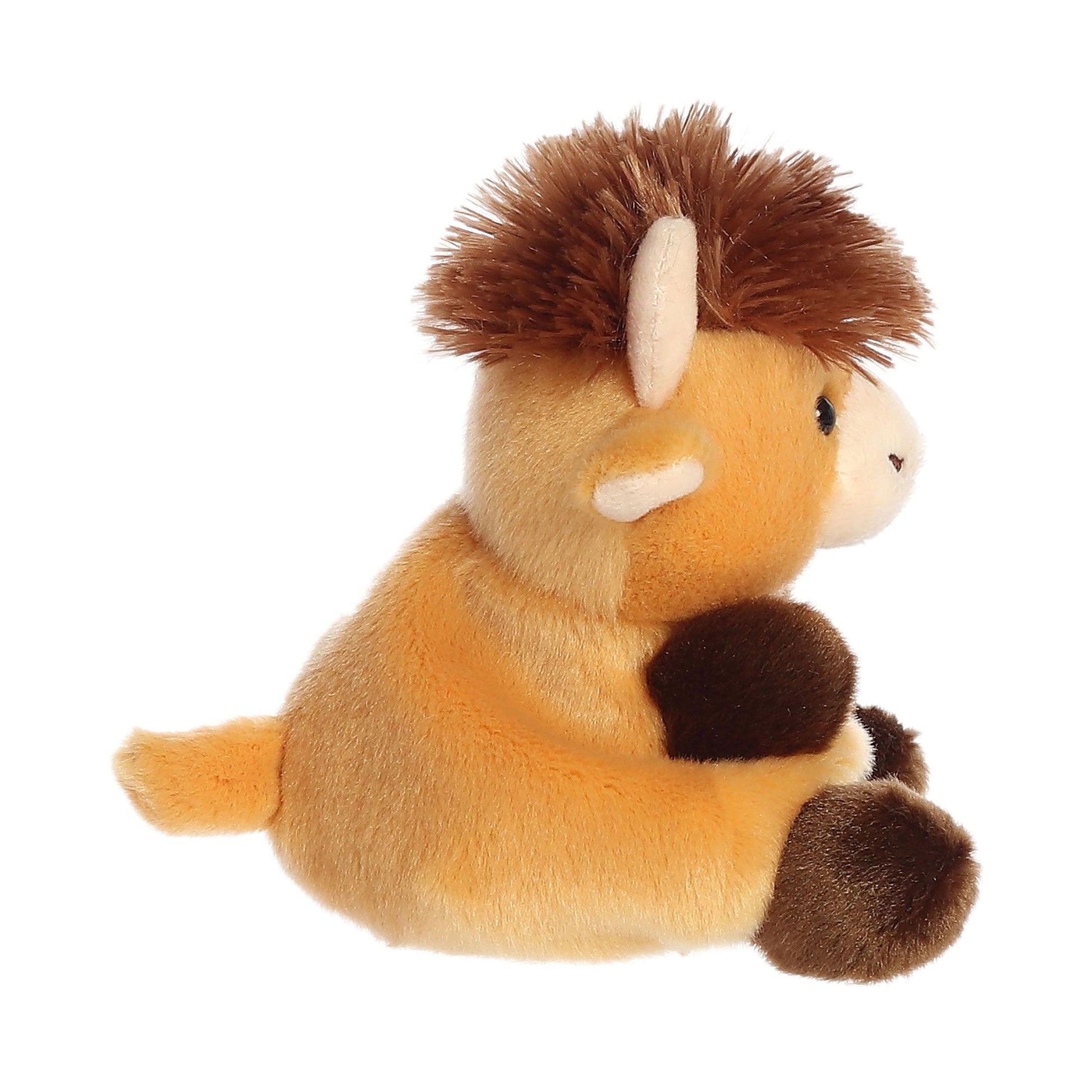 A side view of the Palm Pal Hubert Highland Cow plush toy by Twice as Sweet, featuring a brown and tan design with a fluffy mane, short horns, and soft, rounded features—part of the adorable Palm Pals collection.