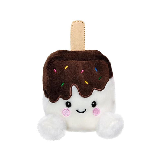 The Twice as Sweet Palm Pal Dolce Ice Cream Bar is a plush toy shaped like an ice cream bar, featuring a brown chocolate top, colorful sprinkles, a smiling face, white feet, and a beige stick—perfect for summer fun.