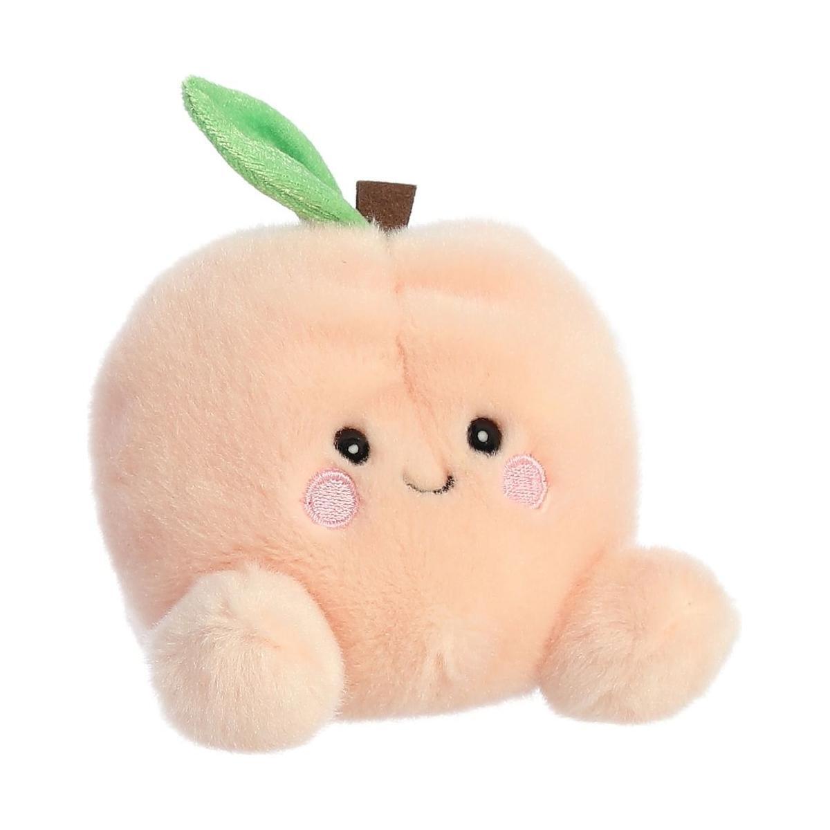 The Twice as Sweet Palm Pal Mellow Peach is a soft, peach-colored plush with embroidered eyes, a smile, small arms, and a green leaf—perfect for relaxation and cozy moments.