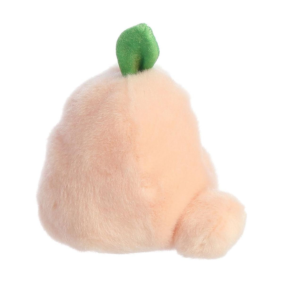 The Twice as Sweet Palm Pal Mellow Peach is a side-view peach-shaped plush with soft light pink fur and a small green leaf on top—perfect for relaxation.