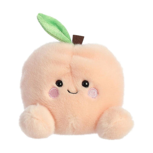 The Twice as Sweet Palm Pal Mellow Peach plush is a soft, round peach-shaped toy with a smiling face, pink cheeks, black eyes, a green leaf on top, and two small fuzzy arms.