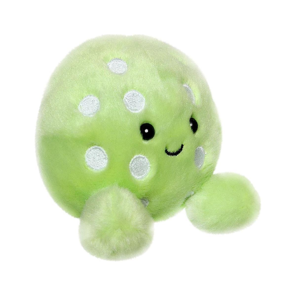 Palm Pal Steve Pickleball by Twice as Sweet is a round, light green plush with white polka dots, two fuzzy arms, and a smiling face with black eyes and a stitched mouth. The background is plain white.