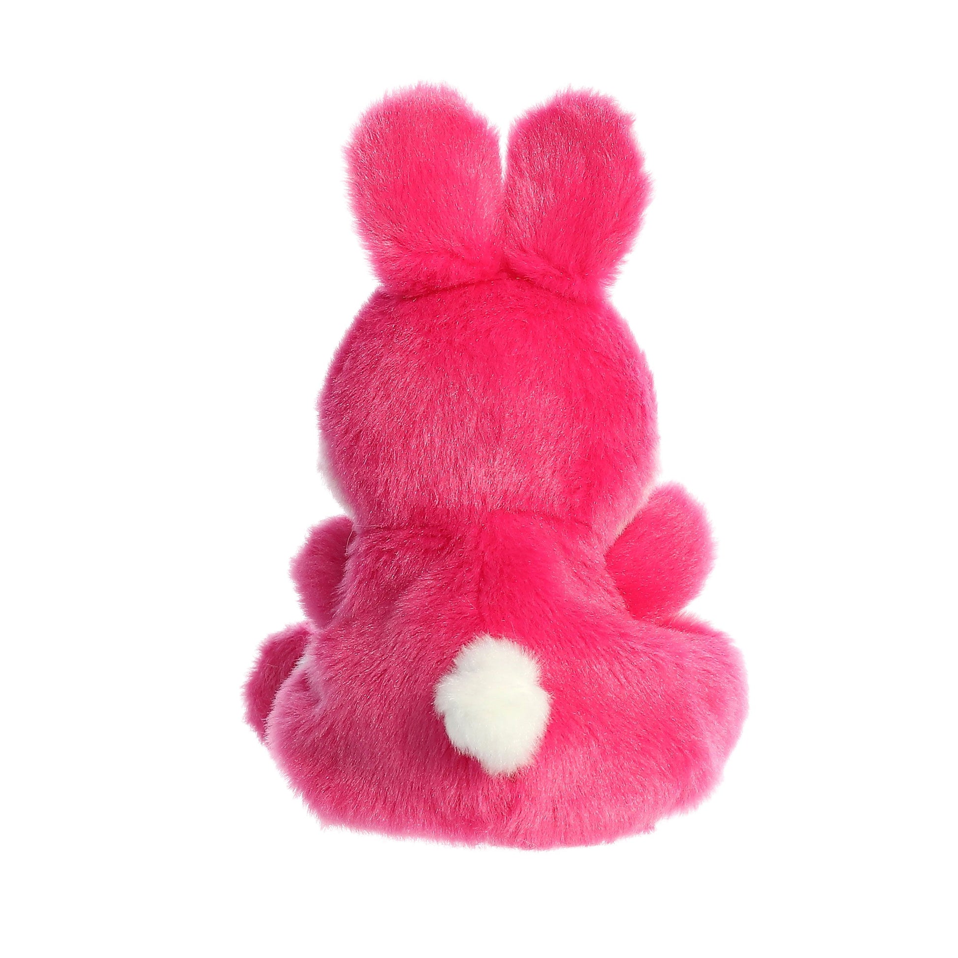 The Twice as Sweet Palm Pal Pixie Pink Bunny sits with its back to the camera, displaying upright ears and a fluffy white tail—a charming addition to any plush collection.