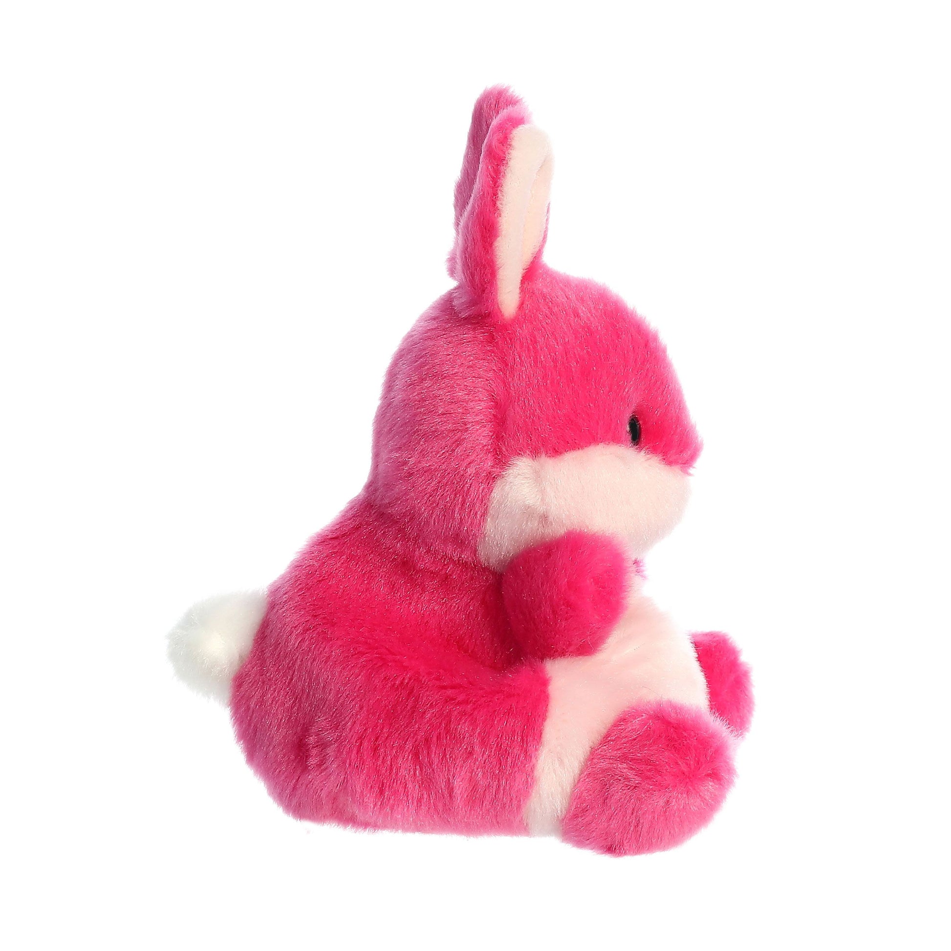The Twice as Sweet Palm Pal Pixie Pink Bunny is a soft plush with a white belly, muzzle, and tail. It sits upright facing right, features large pink ears and black eyes, making it an adorable stuffed animal.