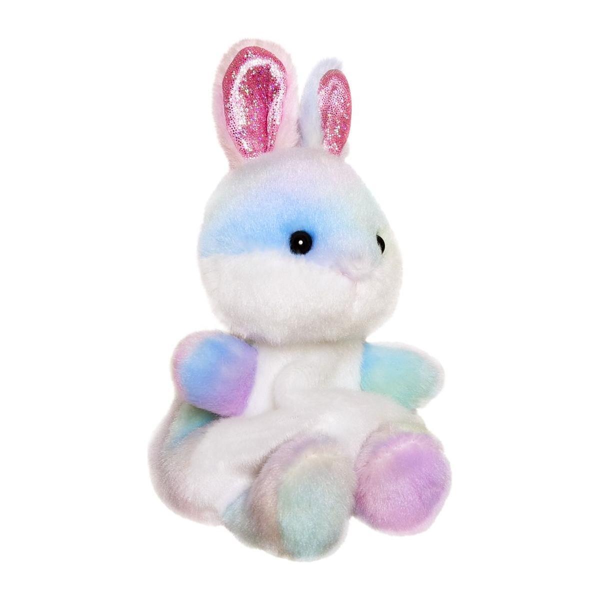The Twice as Sweet Palm Pal Opal Rainbow Bunny is a pastel plush with glittery pink ears, black button eyes, and soft fur in white, blue, purple, and pink—great as party decor or a cuddly companion against a white background.