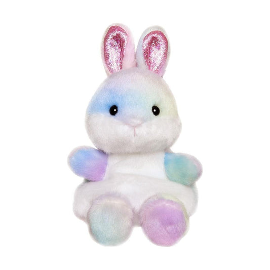 The Twice as Sweet Palm Pal Opal Rainbow Bunny is a pastel plush toy with shiny pink inner ears, black eyes, and a small pink nose, sitting upright against a white background and radiating party charm.