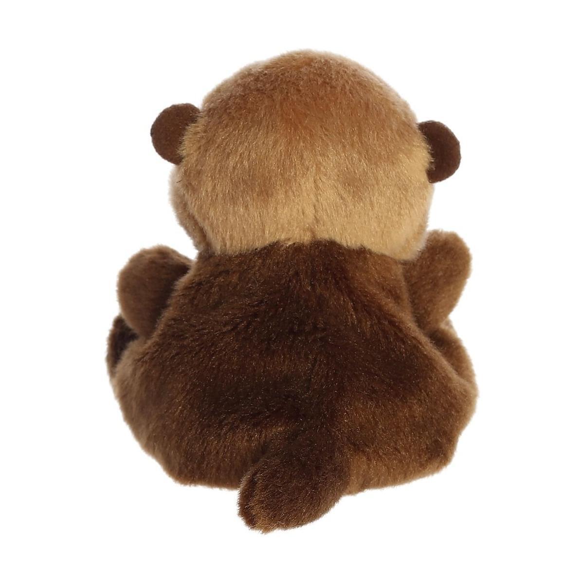 The Twice as Sweet Palm Pal Selena Sea Otter plush toy features small round ears, a short tail, and soft fur. Shown from the back against a white background, it’s perfect for cuddles or inspiring aquatic adventure dreams.