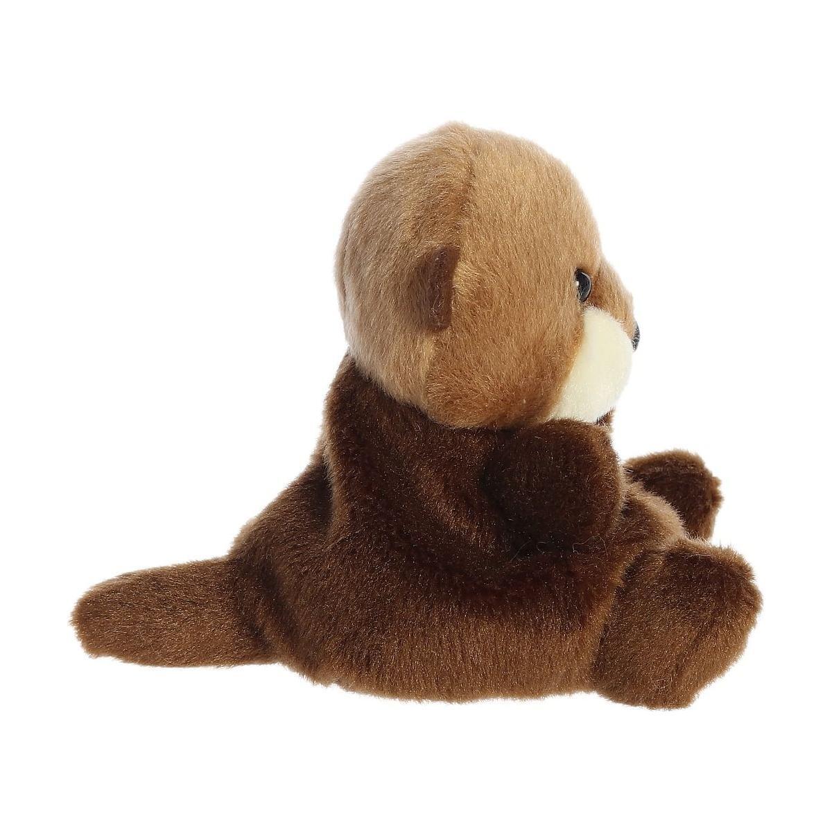 Twice as Sweet’s Palm Pal Selena Sea Otter plush sits upright facing right, showing its tail and paws. With soft brown and tan fur, this cuddly toy is ready for aquatic fun against a plain white background.