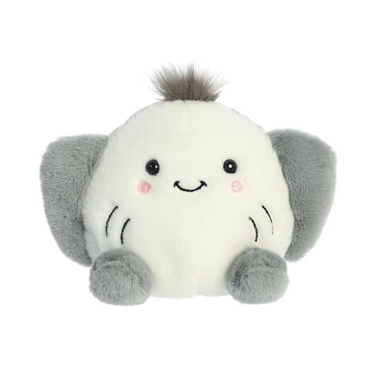 A round, plush elephant toy with gray ears and feet sits beside the Twice as Sweet Palm Pal Flapjack Stingray, making the perfect pair of cuddly stuffed animals.