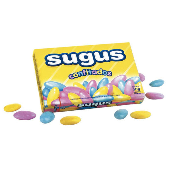 A yellow box labeled Sugus Confitados 50g (Argentina) by Twice as Sweet, with colorful pink, blue, and yellow oval candies spilling out onto a white surface.