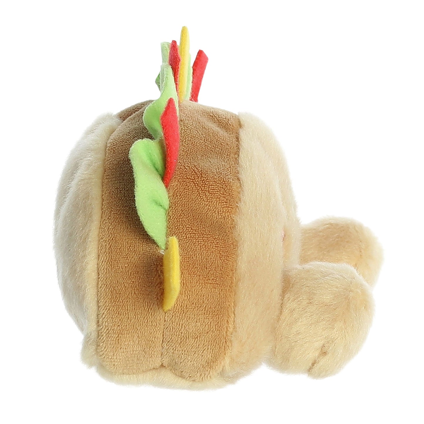 The Twice as Sweet Palm Pal Fiesta Taco is a colorful plush toy with tan, soft fabric and vibrant felt lettuce, cheese, and tomato. Shaped like a taco and playfully posed on its side—perfect for parties or fun displays!.