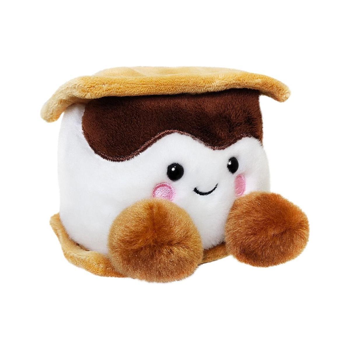 The Palm Pal Toastee Smore by Twice as Sweet is a cozy campfire plush shaped like a s’more, featuring a brown top and bottom, white center, cute smiling face with pink cheeks, and two fluffy feet—all set against a white background.