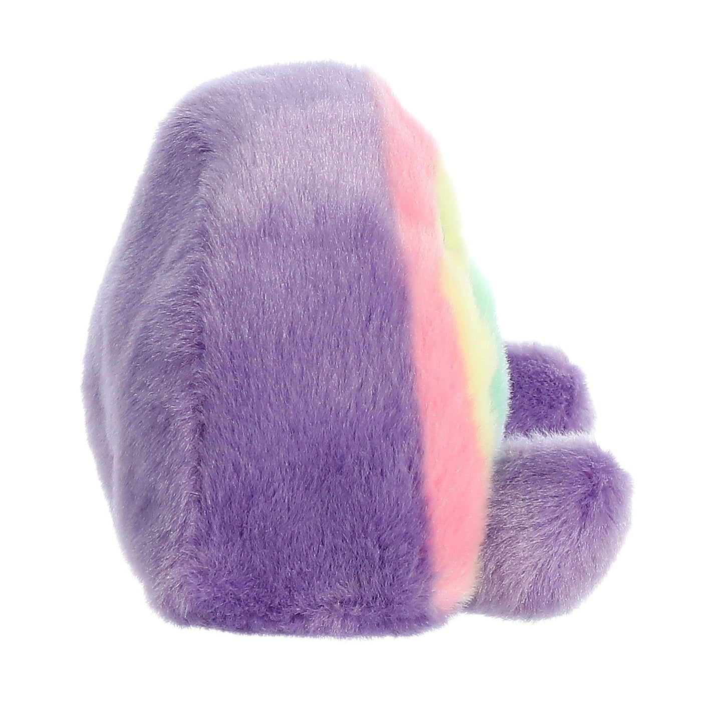 Twice as Sweet’s Palm Pal Vivi Rainbow is a soft, pastel purple stuffed animal with rainbow stripes on its front, two small rounded feet, and plush, fluffy fabric. The toy is shown from a side angle.